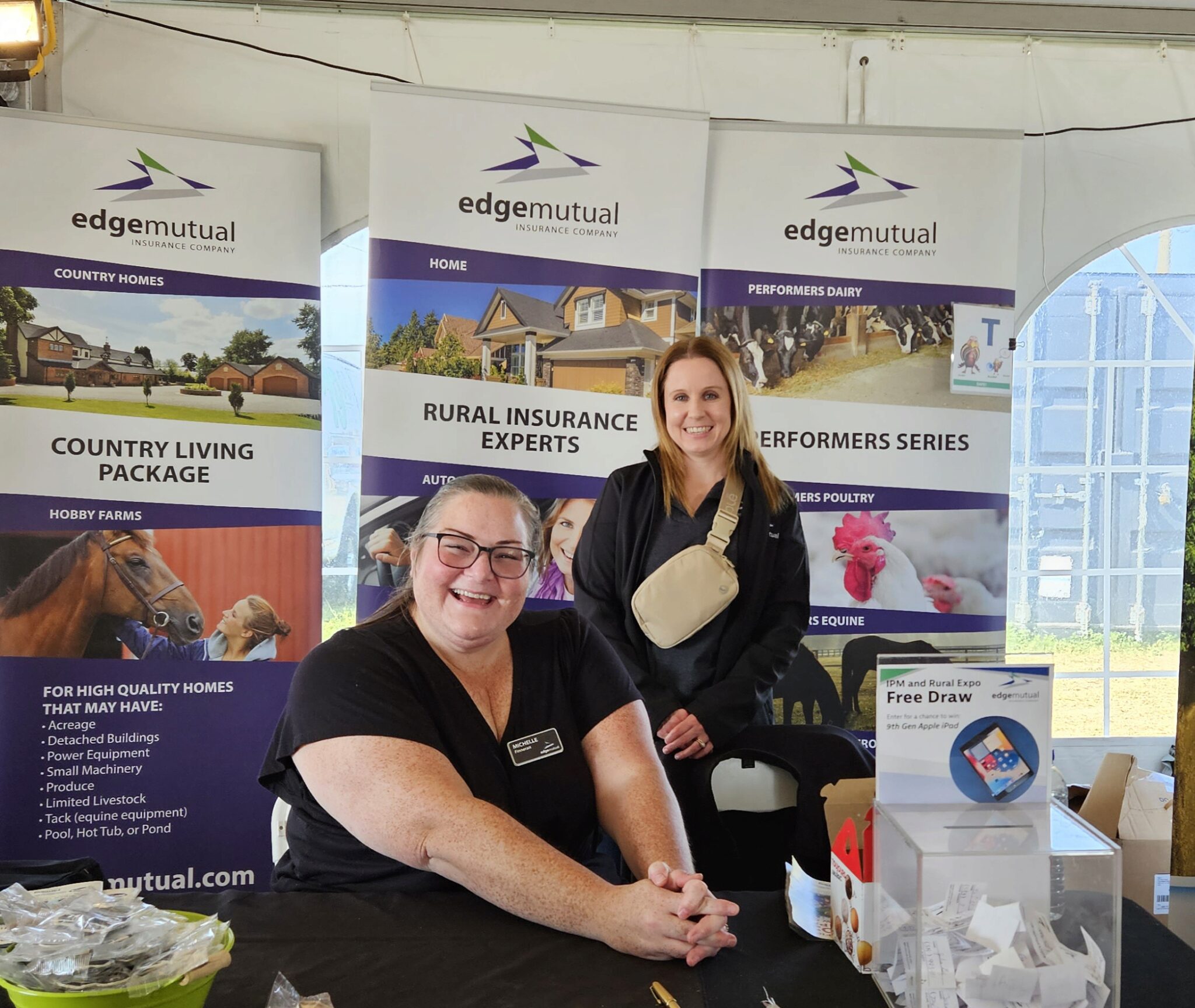 Edge employees Michelle Finneran and Robyn Stadnik volunteering in the Ontario Mutuals tent.